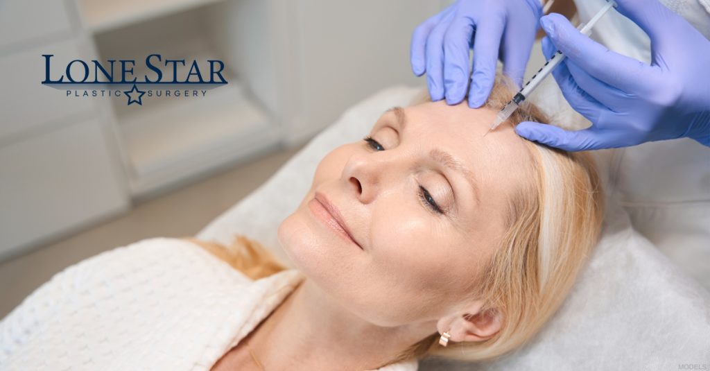 Woman receiving facial BOTOX injections during a cosmetic treatment (model)