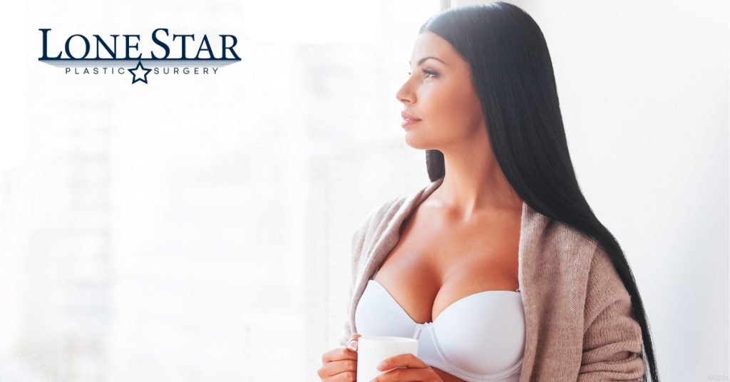 A woman in a bra holding a cup of coffee. (Model)