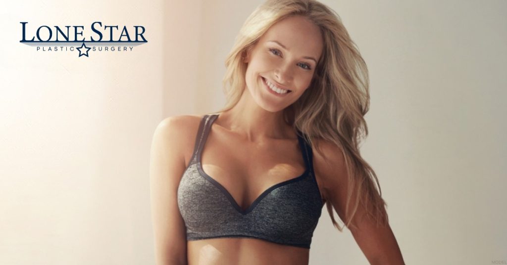 A woman in a sports bra (model) Lone Star Plastic Surgery Logo